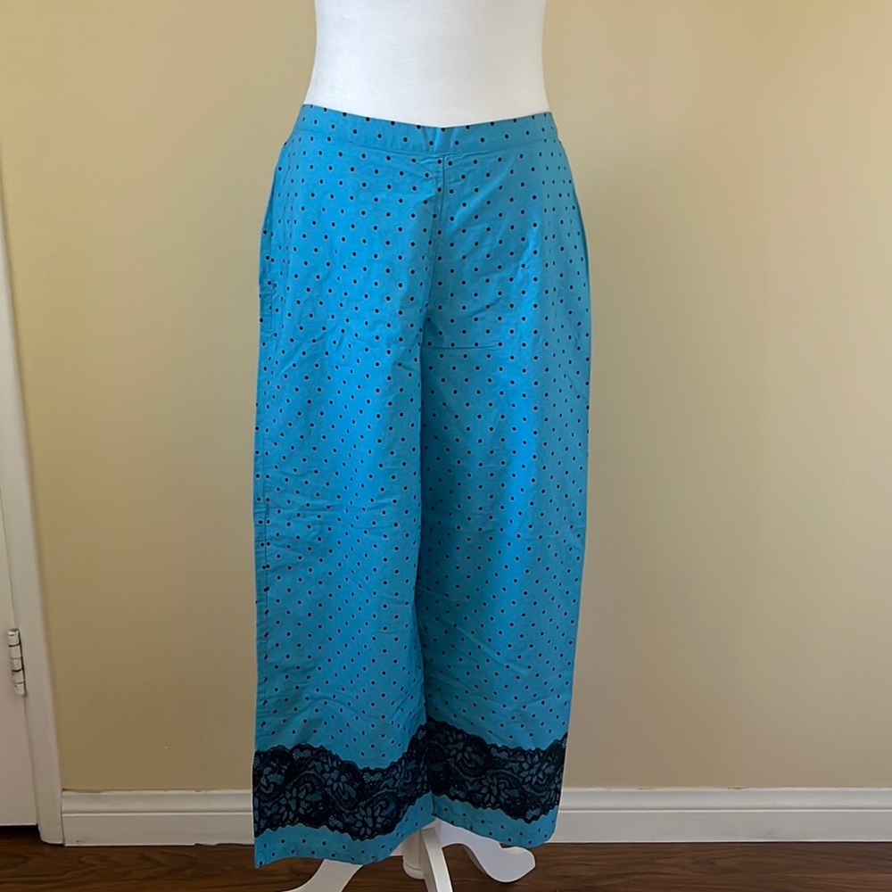 Blue polka dot pajama pants with lace detail on bottom
